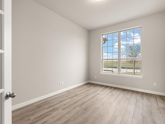 Quietly nestled in the front of the home, the study features gorgeous flooring and large windows.