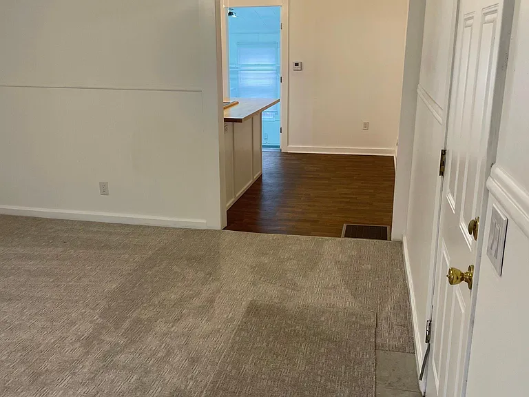 living room looking into kitchen and laundry room beyond