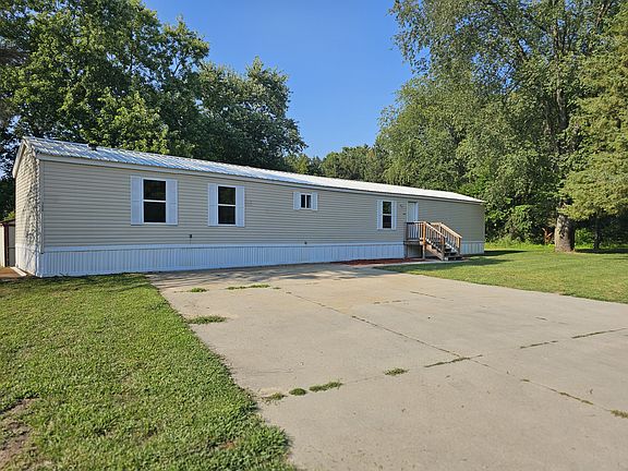 Exterior of home. Very large driveway.