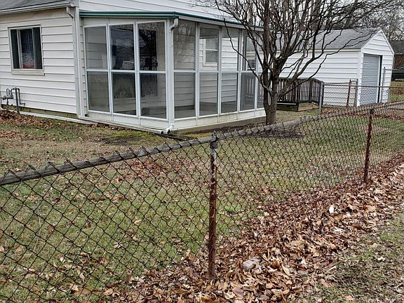 Side view, shows garage and sun porch.