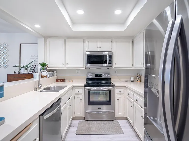 Galley style kitchen with updated stainless steel appliances