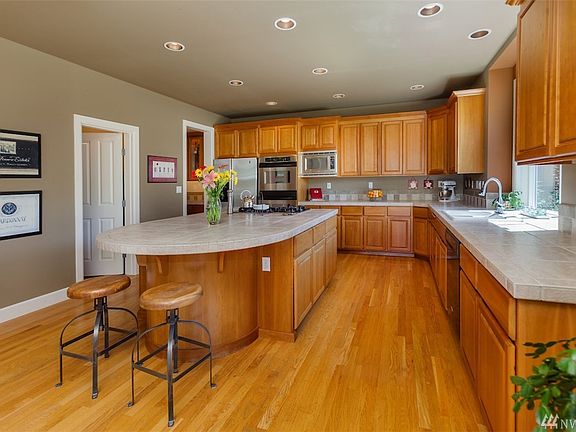 A chef's dream kitchen. Double ovens, five burner gas cooktop and endless counter space. To the left is the walk in pantry that will please any baker