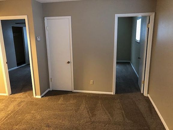 View from front door toward two bedrooms and coat closet