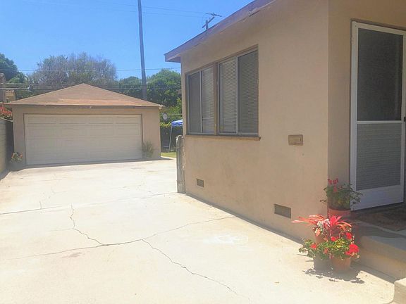 Rear unit's private 2-car garage and driveway parking