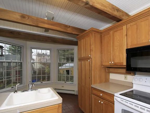 Sink and pantry area in kitchen and access to office space.