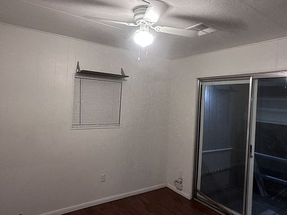 Bedroom 1.
View from doorway.
Sliding glass door for separate private entrance.
Ceiling fan, mirrored closet doors, window.