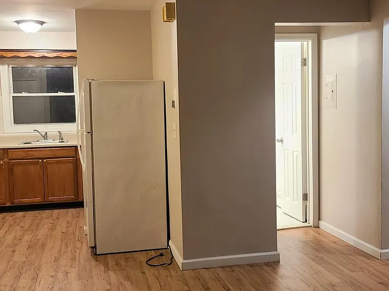 Open layout: view from large living room looking toward kitchen, bathroom and bedrooms.