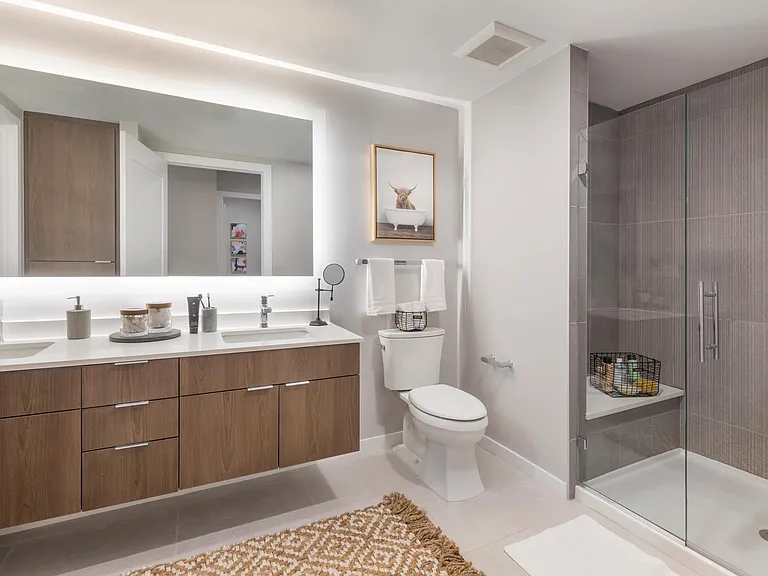 Designer bathrooms at Modera LoHi feature quartz countertops and double vanities in select apartments.