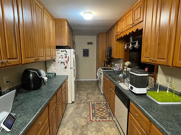 Kitchen facing west from dining area. All appliances included and in excellent working condition. Oak cabinets with abundant storage.
