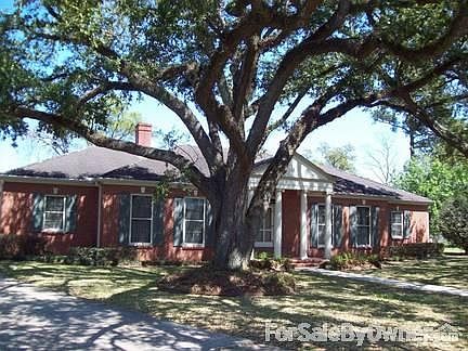 Front facade with live oak trees
