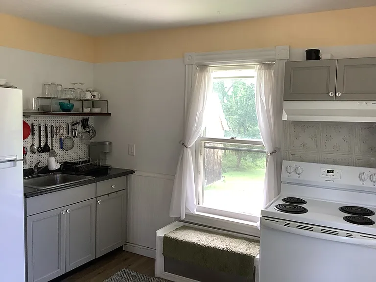 Kitchen, overlooks parking area & back yard foliage.