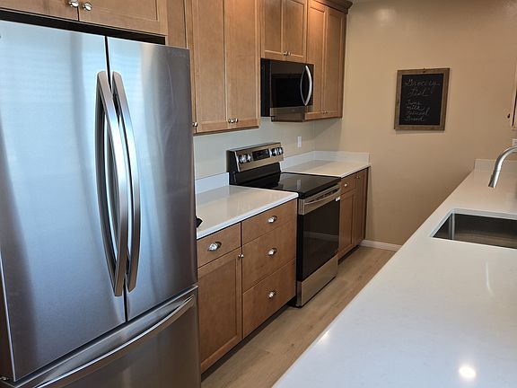 Updated appliances in quartz countertop kitchen.