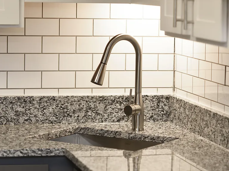 Kitchen with granite counters and goose-neck sink