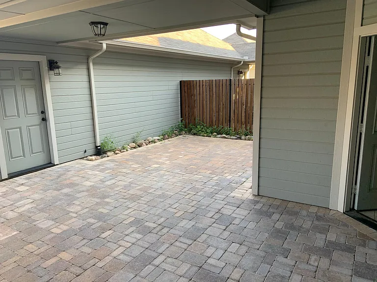 Paved backyard patio to the two car garage.
