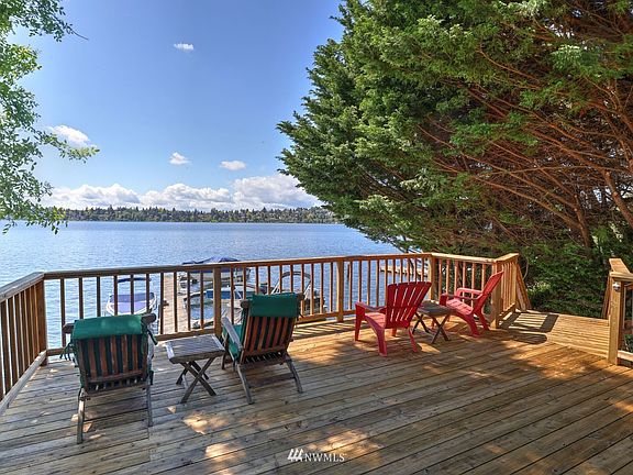 The shared waterfront dock has been recently updated with a dedicated new boat lift for this property, spacious shared platform deck and fire pit that is sure to host a great party>