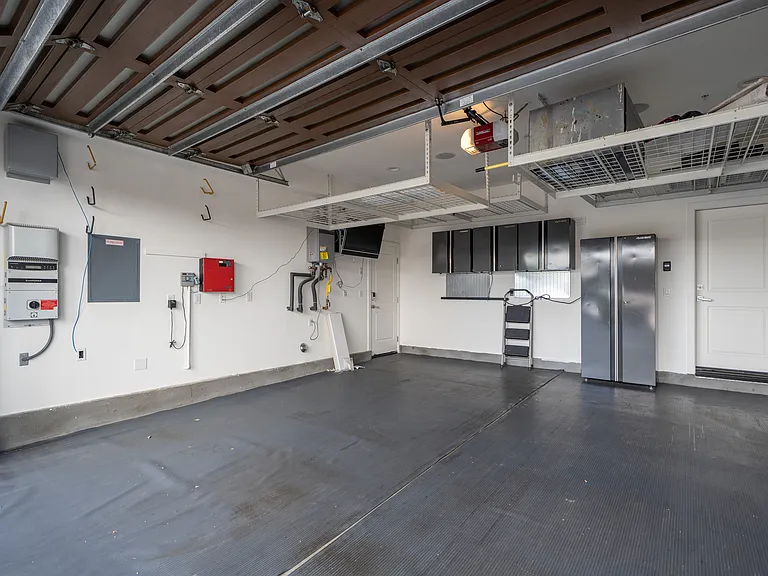 2-car garage with EV charging and overhead storage shelves