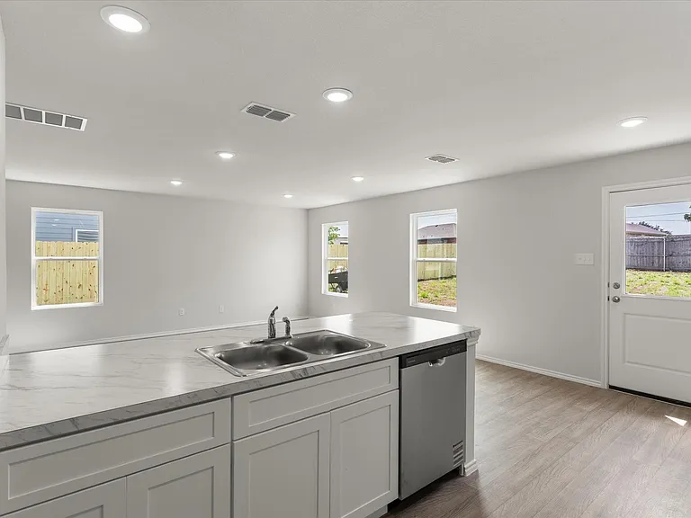 Kitchen island with a double basin stainless steel sink and a stainless steel dishwasher