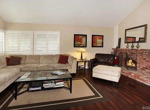 Living Room showing custom built wood shutters and fireplace