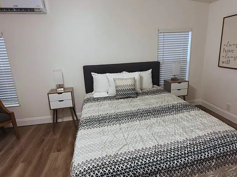 Spacious queen bed with premium linens and plush pillows for ultimate comfort.