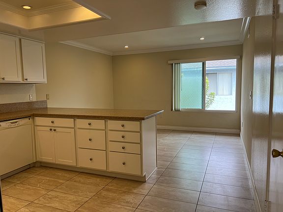 Updated kitchen with updated tile flooring and recessed lighting