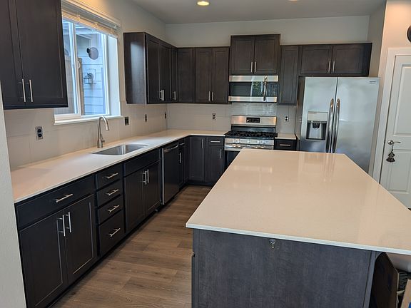 Open large kitchen with latest appliances and island