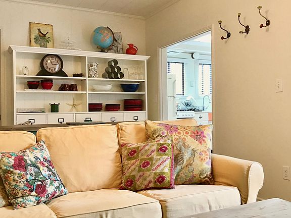 Comfortable Pottery Barn sofa and book case with a lot of st