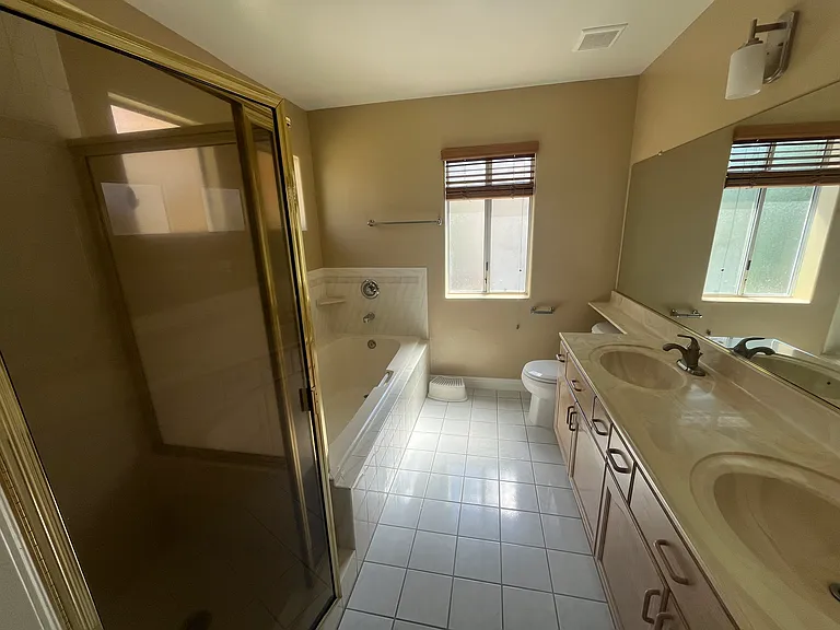 Master bathroom with bathtub, shower stall and double sinks