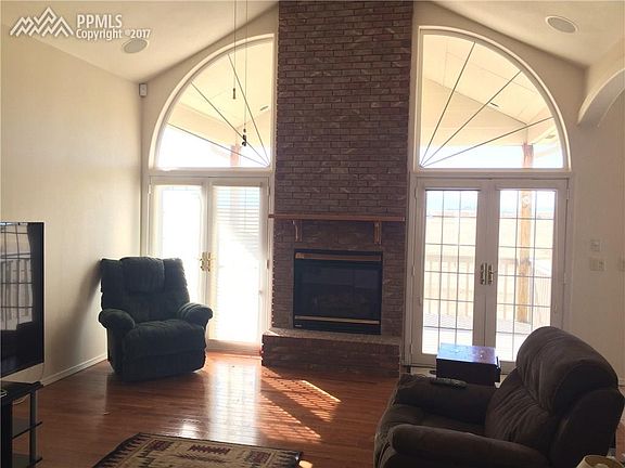 Beautiful main level living room with entrance to covered deck.  Lots of light a