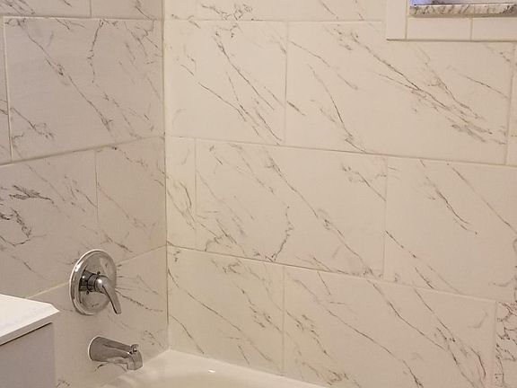 Newly renovated bathroom with new tile, new bathtub, new floor, etc!