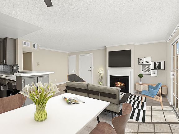 Living room with hardwood floor and view of dining room and kitchen area.