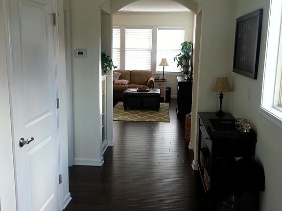 Entry Hall with view into open living/dining/kitchen area
