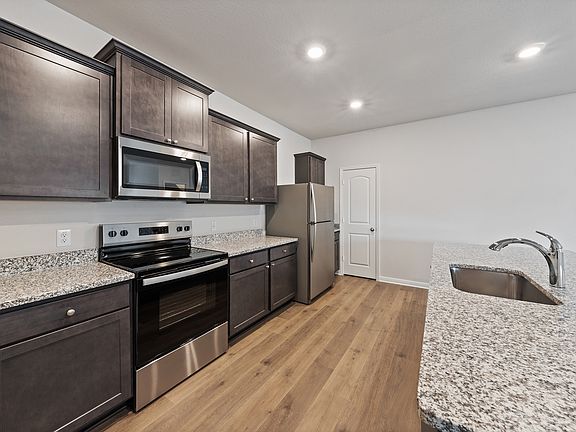 The kitchen has beautiful wood cabinetry.
