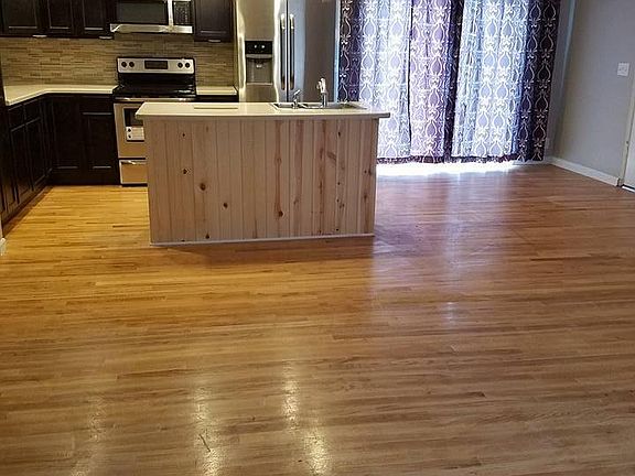 Open floor plan includes living room, dining, and kitchen. (
