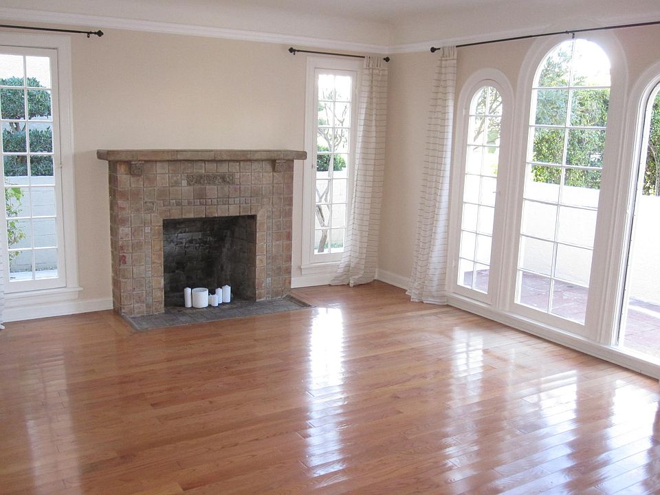 Large and well-lit living room leading out to a fenced yard and front patio.