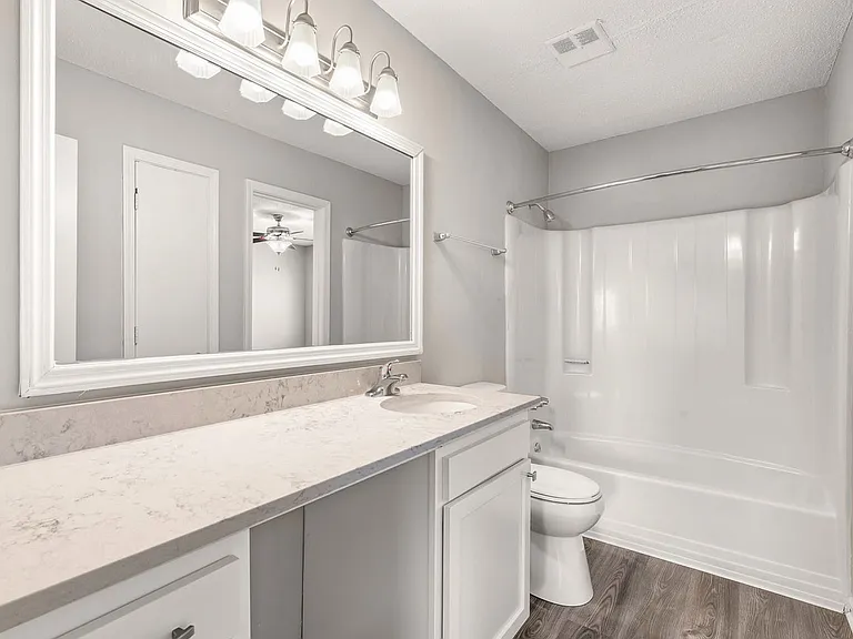 Newly renovated bathroom designed with modern finishes and ample counter space.