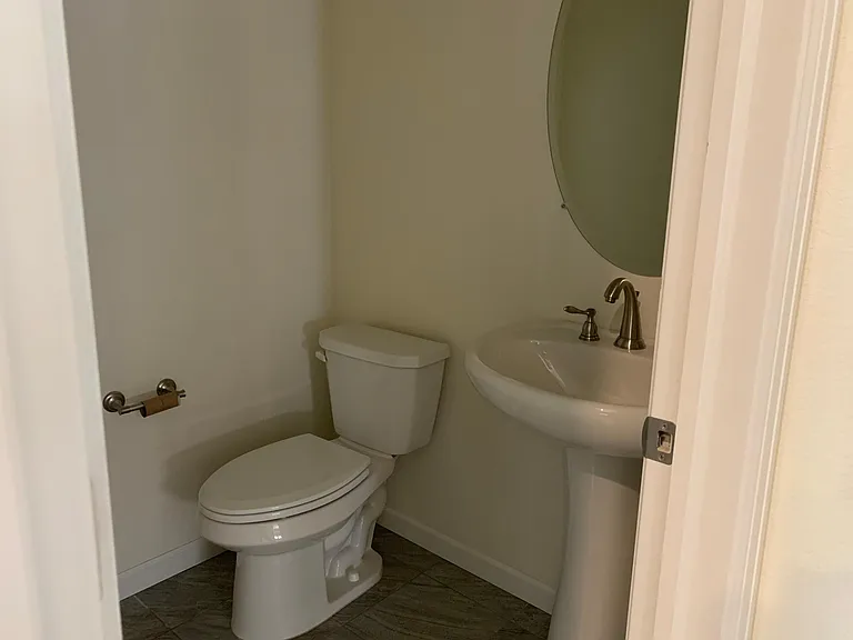 Spacious Powder Room just off Garage entrance, tile area coming off garage door with coat closet