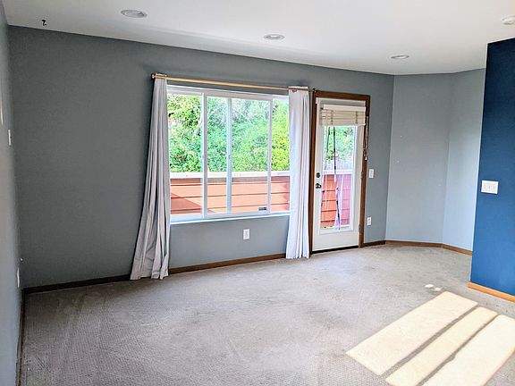 Living room and balcony visible through the window.