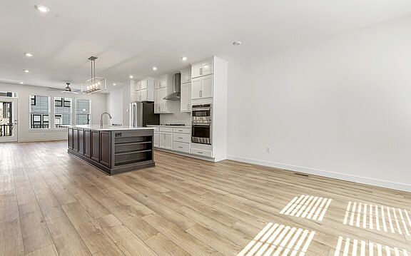 Dining area looking into kitchen with living area in the background.