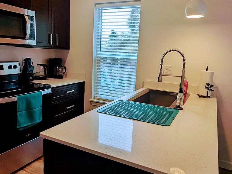 Full kitchen with starter supplies of trash bags, paper towels, coffee, tea, stevia, sugar, olive oil, salt & pepper, kitchen surface cleaner (7th 
Generation), Lavazza coffee and coffee filters.
