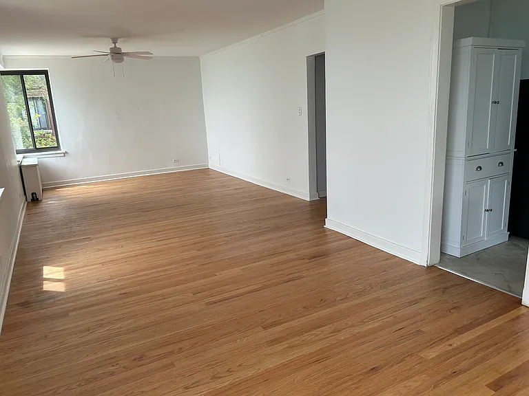 View looking into living/dining combo area and kitchen from northeast corner window.
