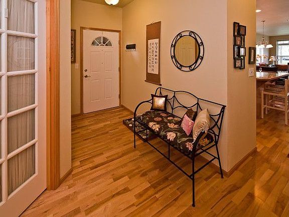 Entry with hardwood floors and french doors to 3rd bedroom/office.