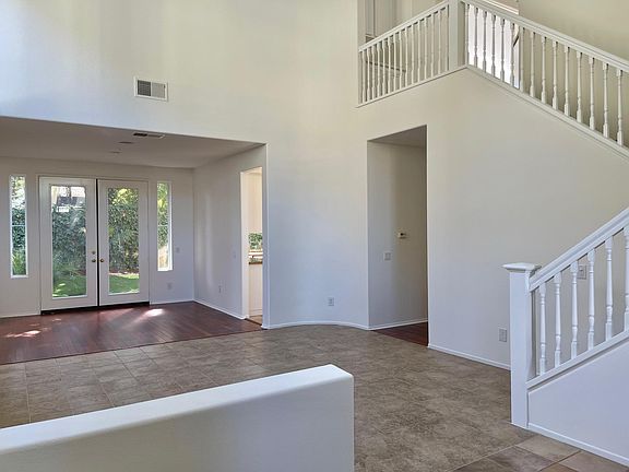 The formal living area and dining area overlooking the backyard.