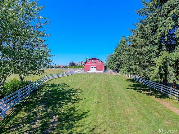 Barn also includes 3 stalls, Tack Room, Wash Rack, and half bath. Separate horse pasture and 2 paddock areas. 