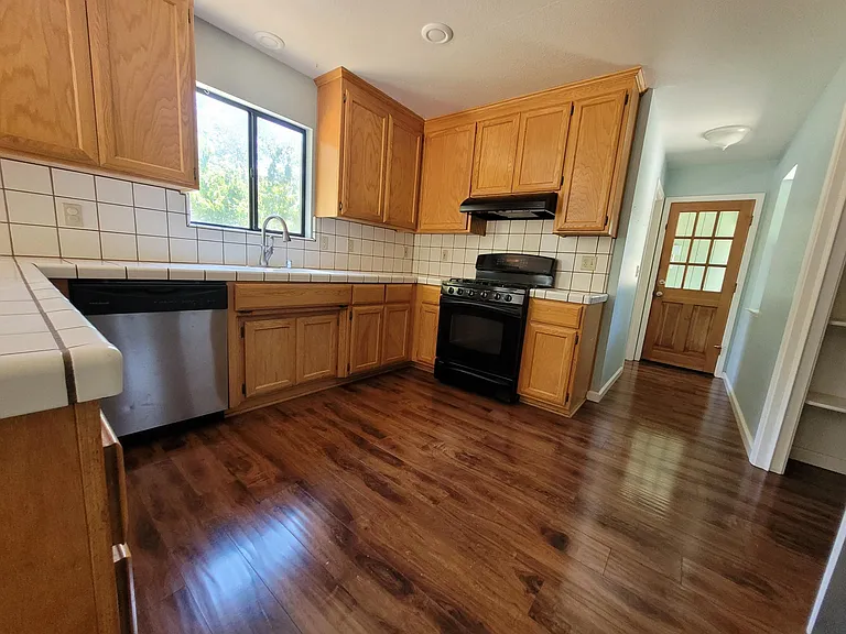 The kitchen has NEW White Granite, and cabinets have been painted White.