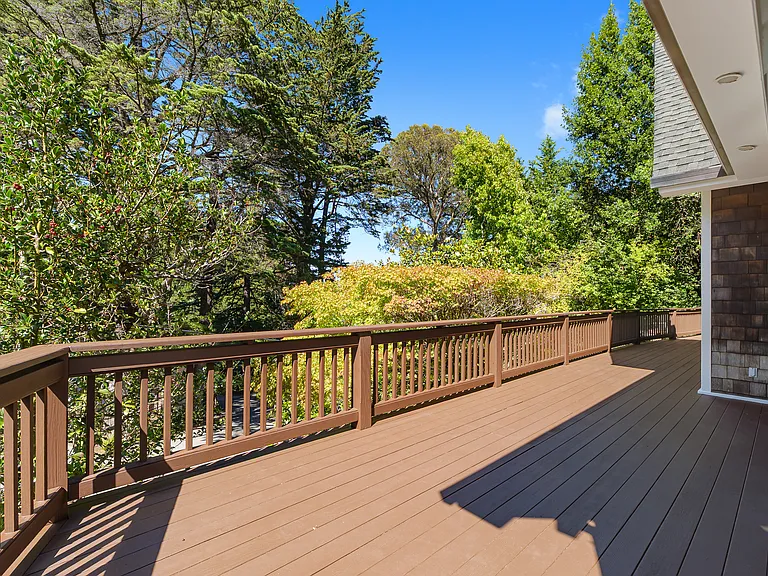 Large wrap-around deck. Seamless entertainment space from kitchen to living room. Kids can freely and safely run around deck and garden/backyard.
