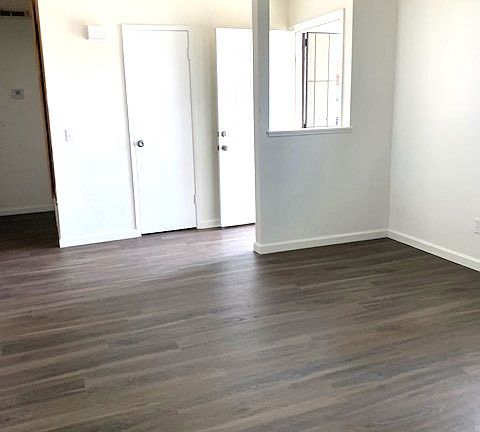 Spacious living room with coat closet and new neutral flooring for any decor concept.