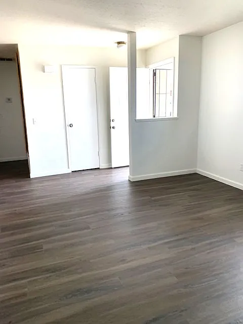 Spacious living room with coat closet and new neutral flooring for any decor concept.