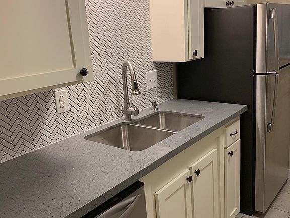Stainless steel refrigerator with icemaker, dishwasher and garbage disposer