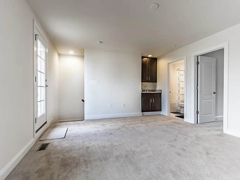 Recreation room / home gym with wet bar leads to outdoor rooftop terrace on top floor