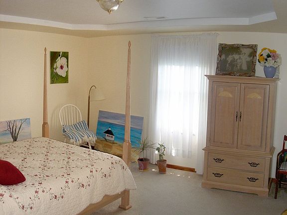 Large master is enhanced by a tray ceiling, walk-in closet, & private bath.